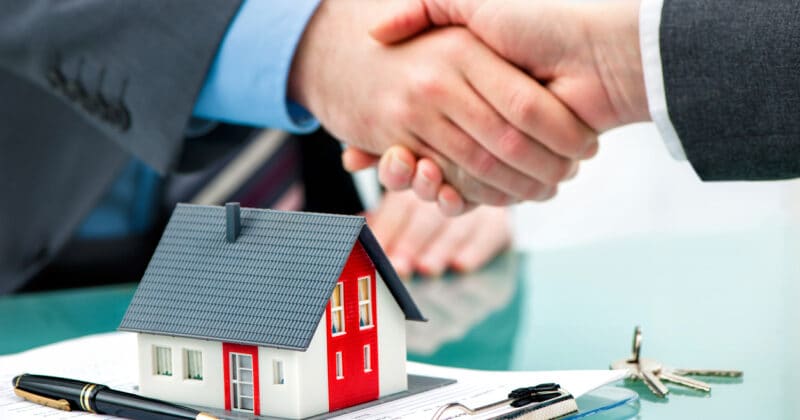 Handshake after signing a property management agreement